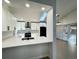 Bright, updated kitchen with white cabinets, sleek appliances, and natural light from a skylight at 9668 Salem Ct, Highlands Ranch, CO 80130