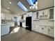 Beautifully updated kitchen with white cabinets, stainless appliances, quartz counters, and a skylight at 9668 Salem Ct, Highlands Ranch, CO 80130