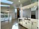 Open floor plan with kitchen and living room featuring a brick fireplace and sliding door access to backyard at 9668 Salem Ct, Highlands Ranch, CO 80130