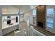Elevated view of open floor plan featuring kitchen, brick fireplace, and hardwood flooring at 9668 Salem Ct, Highlands Ranch, CO 80130