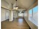 Bright, airy living room features hardwood floors, a modern chandelier, and ample natural light at 9668 Salem Ct, Highlands Ranch, CO 80130