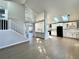 Stunning open-concept living space with modern white kitchen, skylights, and beautiful staircase at 9668 Salem Ct, Highlands Ranch, CO 80130
