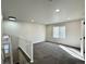 Bright loft area features neutral decor, gray carpet, and ample natural light from the window at 9668 Salem Ct, Highlands Ranch, CO 80130