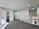 Upstairs loft area with carpet, neutral paint, and railing overlooking stairs and entry at 9668 Salem Ct, Highlands Ranch, CO 80130