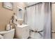 Clean bathroom with shower/tub combo, vanity, and toilet at 2701 S Knox Ct, Denver, CO 80236