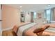 Bedroom with wood floors, dresser, and view to entry hall with decorative wall art at 2701 S Knox Ct, Denver, CO 80236