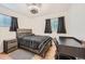 Bedroom with gray bedding, a desk, and hardwood floors at 2701 S Knox Ct, Denver, CO 80236