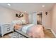 Cozy bedroom featuring modern decor, wood floors, and a comfortable bed with stylish bedding at 2701 S Knox Ct, Denver, CO 80236