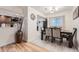 Bright dining area featuring a modern light fixture and an open view of the kitchen at 2701 S Knox Ct, Denver, CO 80236