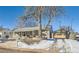 House exterior with stone accents and landscaping at 2701 S Knox Ct, Denver, CO 80236