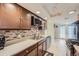 Bright kitchen features modern appliances and wood cabinets at 2701 S Knox Ct, Denver, CO 80236