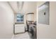 Bright laundry room with washer, dryer, cabinets, and countertop at 2701 S Knox Ct, Denver, CO 80236