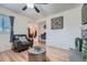 Comfortable living room with hardwood floors, ceiling fan, and chair next to doorway and built-in desk at 2701 S Knox Ct, Denver, CO 80236