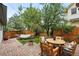 Charming backyard featuring a paved patio, fire pit, and cozy hammock, perfect for outdoor relaxation at 8276 E 28Th Dr, Denver, CO 80238