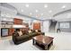Open-concept basement with bar area, recessed lighting, and comfortable sectional seating at 8276 E 28Th Dr, Denver, CO 80238