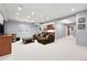 Spacious basement with modern lighting, wet bar, and comfortable seating area at 8276 E 28Th Dr, Denver, CO 80238