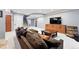 Finished basement with plush seating, built-in cabinetry, and a stylish TV console at 8276 E 28Th Dr, Denver, CO 80238