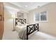 Bedroom features a single bed, window and dark wood accents at 8276 E 28Th Dr, Denver, CO 80238