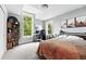Bright bedroom featuring a large window, desk, bookshelf, and modern decor at 8276 E 28Th Dr, Denver, CO 80238
