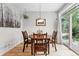 Cozy dining room with hardwood floors, natural light, and seating for four, perfect for intimate gatherings at 8276 E 28Th Dr, Denver, CO 80238