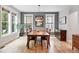Bright dining room with grey accent wall, hardwood floors, and rustic wooden table at 8276 E 28Th Dr, Denver, CO 80238