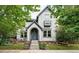 Charming two-story home with light grey exterior and a inviting front porch and a light blue front door at 8276 E 28Th Dr, Denver, CO 80238