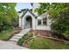 View of front of house featuring stone steps leading to the front door and professionally landscaped yard at 8276 E 28Th Dr, Denver, CO 80238