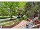 View of front yard featuring a brick path and mature shade trees at 8276 E 28Th Dr, Denver, CO 80238
