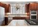 Well-equipped kitchen features granite countertops, stainless steel appliances, a gas cooktop, and ample cabinet space at 8276 E 28Th Dr, Denver, CO 80238