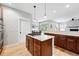 Modern kitchen featuring granite countertops, stainless steel appliances, a gas cooktop, and seamless flow to dining area at 8276 E 28Th Dr, Denver, CO 80238