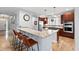 Kitchen bar featuring seating, granite countertops, modern appliances, and hardwood floors for a cozy cooking experience at 8276 E 28Th Dr, Denver, CO 80238