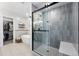 Modern main bathroom with a glass-enclosed shower, soaking tub, and walk-in closet at 8276 E 28Th Dr, Denver, CO 80238