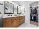 Double vanity and a walk-in closet in a well-lit bathroom, offering ample space at 8276 E 28Th Dr, Denver, CO 80238