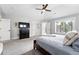 Another angle of spacious main bedroom featuring a television and access to an ensuite bath at 8276 E 28Th Dr, Denver, CO 80238