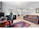 Bright home office with hardwood floors, area rug, and comfortable seating area adjacent to the workspace at 8276 E 28Th Dr, Denver, CO 80238