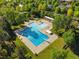 Stunning aerial view of a community pool featuring pristine blue water and lush greenery, perfect for recreation at 8276 E 28Th Dr, Denver, CO 80238