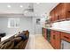 A modern wet bar in basement features wood cabinetry and sleek countertops at 8276 E 28Th Dr, Denver, CO 80238