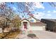 Inviting two-story home featuring a covered porch, a two-car garage, and fall foliage at 10101 E 112Th Way, Commerce City, CO 80640
