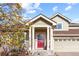 Charming home featuring a red front door and stone accents, under a covered porch at 10101 E 112Th Way, Commerce City, CO 80640