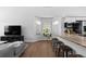 Modern living room with a view of the kitchen featuring bar stool seating and granite countertop at 10101 E 112Th Way, Commerce City, CO 80640