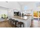 Well-lit kitchen featuring stainless steel appliances, an island with seating, and hardwood floors at 10101 E 112Th Way, Commerce City, CO 80640