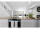 Open kitchen with granite counters and stainless steel oven and cooktop at 10101 E 112Th Way, Commerce City, CO 80640