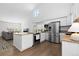 Bright kitchen with stainless steel appliances, island, granite counters, and hardwood floors at 10101 E 112Th Way, Commerce City, CO 80640