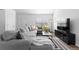 Stylish living room with large sectional sofa, natural light, and modern decor at 10101 E 112Th Way, Commerce City, CO 80640