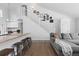 Cozy living room with a view of the kitchen, featuring a staircase and modern design at 10101 E 112Th Way, Commerce City, CO 80640