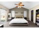 Vaulted main bedroom with a ceiling fan, two windows, and carpet floors at 10101 E 112Th Way, Commerce City, CO 80640