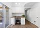 Office space with built-in desk, cabinetry, and natural light from a sliding glass door at 10101 E 112Th Way, Commerce City, CO 80640
