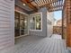 Back deck with wood-look deck and access to sliding glass doors and a wood gate at 5755 Boston St, Denver, CO 80238