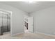 Neutral-toned bedroom with closet, carpeted floors, and a doorway leading to a carpeted staircase at 5755 Boston St, Denver, CO 80238