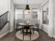 Bright dining room featuring a modern round table, pendant lighting, and large windows with sheer curtains at 5755 Boston St, Denver, CO 80238